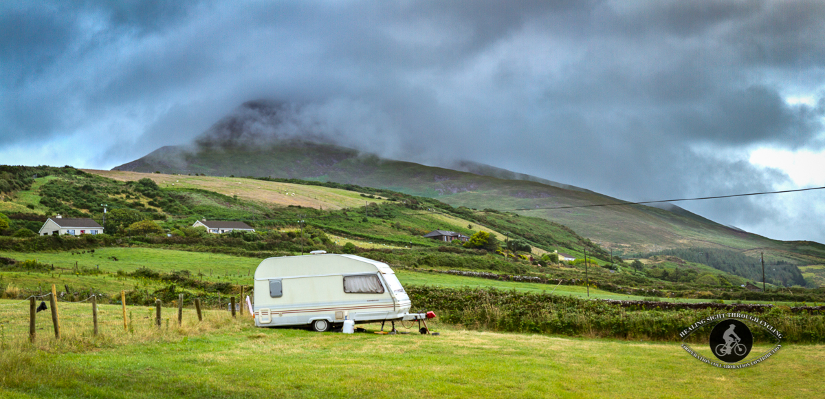 Caravan in front of stormy clouds on mountain - panorama