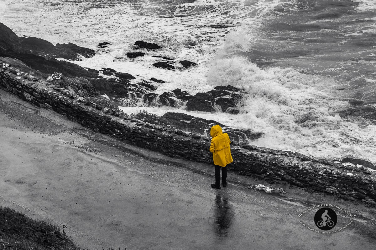 Man on road with waves in the Wild Atlantic Way near Dingle - BW Selective colour