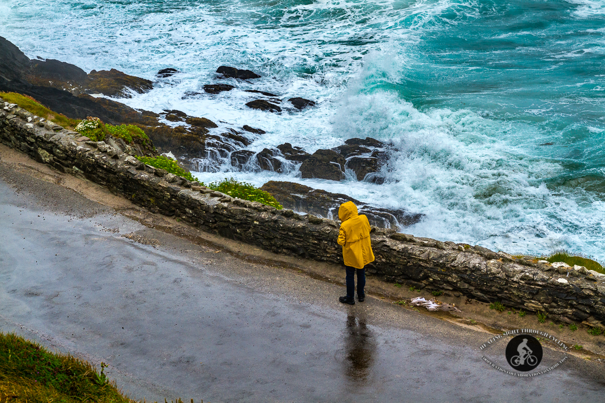 Man on road with waves in the Wild Atlantic Way near Dingle